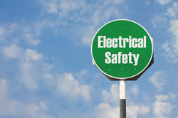 Green stop sign with Electrical Safety caption