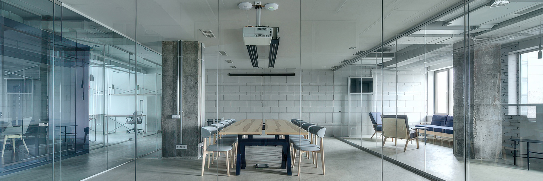 Modern office conference room with ceiling mounted projector and professional audio visual system installation commercial AV services for businesses