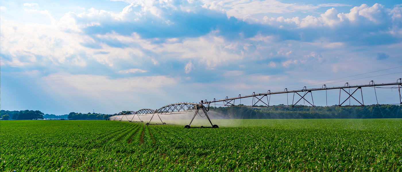 Center pivot irrigation system operating over green agricultural field professional electrical services for farm irrigation equipment and fertilizer systems