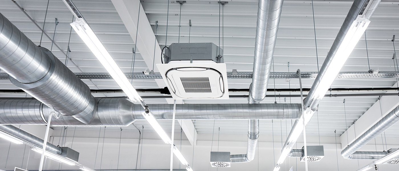 Commercial ceiling with LED linear lighting and HVAC ductwork installation in modern business space professional electrical services for commercial buildings