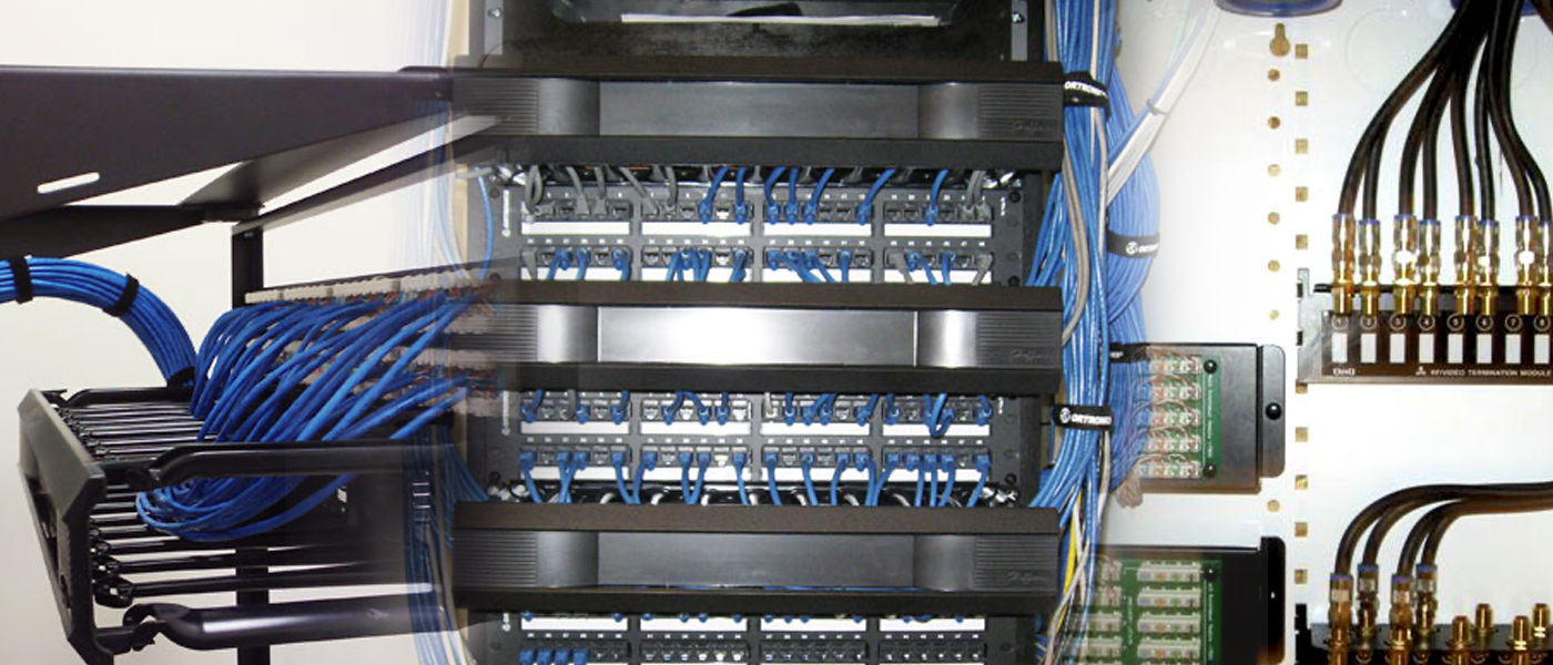 Professional AV equipment rack with organized blue network cables and media components in closet professional home media system installation services